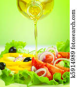 olive oil stream and healthy fresh vegetable salad