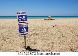 sign of bathing area on the beach for the safety of bathers compared to boats . 