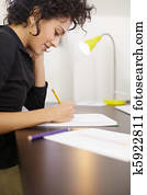 Woman working with sketches in fashion design studio