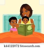 african american mother reading a book to son and daughter in bed before going to sleep