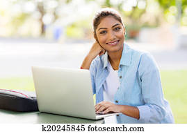 indian university student using laptop computer outdoors