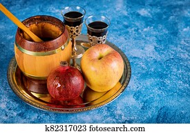 On the table in the synagogue are the symbols of Rosh Hashanah apple and pomegranate On the table in the synagogue are the symbols of Rosh Hashanah apple and pomegranate