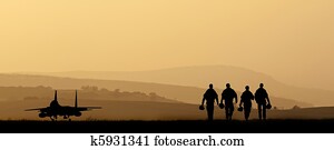 Silhouette of military attack aircraft against vibrant sunset sk Silhouette of military attack aircraft against vibrant sunset sk