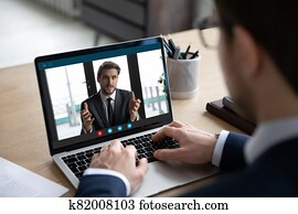 Back view of businessman have video call with business partner Back view of businessman have video call with business partner