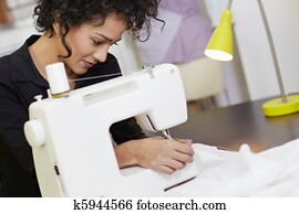 Fashion designer with sewing machine Fashion designer with sewing machine