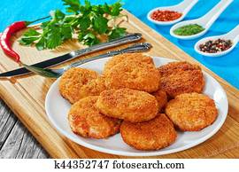 juicy delicious chicken, pork, beef breaded cutlets on white platter