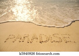 Paradise Written in Sand on Beach