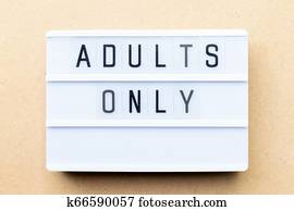 White lightbox with word adults only on wood background