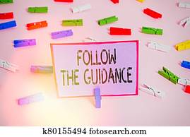Writing note showing Follow The Guidance. Business photo showcasing controlling a course of projectile by builtin mechanism Colored clothespin papers empty reminder pink floor office pin.