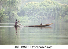 Man in Traditional Boat on Tropical River Volta in Ghana, West A