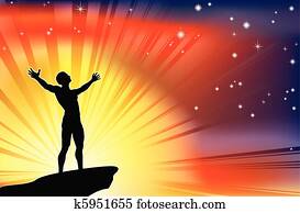 Man on cliff top with arms raised Man on cliff top with arms raised