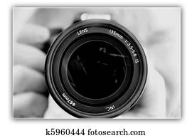 photographing lens in the hands of the photographer