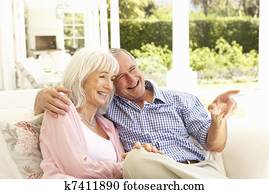 Portrait Of Senior Couple Relaxing Together On Sofa