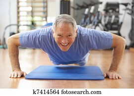 Senior Man Doing Press Ups In Gym Senior Man Doing Press Ups In Gym