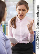 Aggressive Businesswoman Shouting At Female Intern Aggressive Businesswoman Shouting At Female Intern
