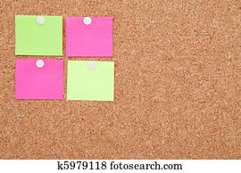 Blank sticky notes pinned on cork memo board