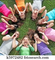 group of kids or teens shouting or singing at summer camp group of kids or teens shouting or singing at summer camp