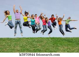 Happy smiling diverse mixed race group jumping