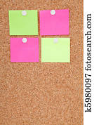 Blank sticky notes pinned on cork memo board 