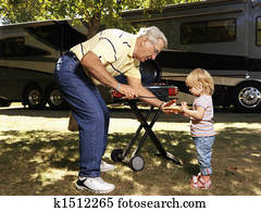 Man and child with hotdog. Man and child with hotdog.