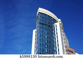 Modern office building over blue sky.