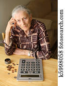 Senior woman counting coins Senior woman counting coins