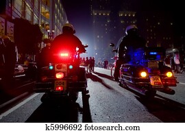 Two Police Officers On Motorcycles In A Night City. Two Police Officers On Motorcycles In A Night City.