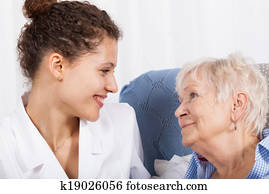 Nurse spending time with elderly lady