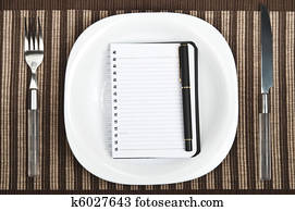Notepad on food plate