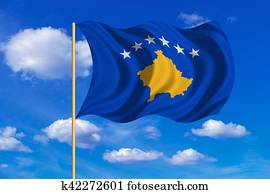 Flag of Kosovo waving on blue sky background