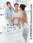 Interior designer shaking hands with happy client