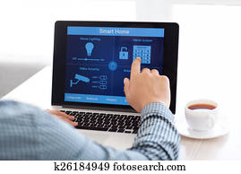 man sitting at a laptop with the program smart home