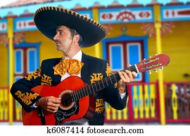 Charro Mariachi playing guitar Mexico houses Charro Mariachi playing guitar Mexico houses