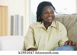 Woman sitting in living room smiling