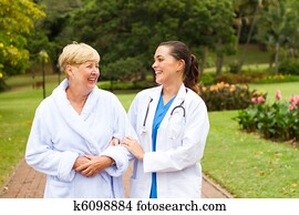 nurse taking senior patient outdoor
