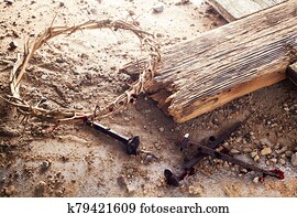 Easter background depicting the crucifixion with a rustic wooden cross, crown of thorns and nails.