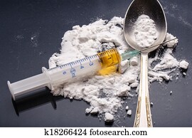 Drug syringe and cooked heroin on spoon Drug syringe and cooked heroin on spoon