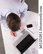 Architect examines plans