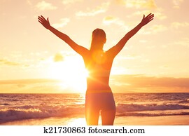Happy Free Woman at Sunset on the Beach Happy Free Woman at Sunset on the Beach