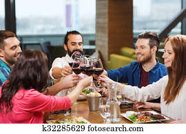 friends dining and drinking wine at restaurant