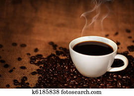 Coffee cup on roasted coffee beans