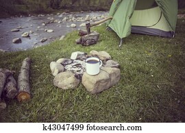 Cooking breakfast on a campfire at a summer camp. Cooking breakfast on a campfire at a summer camp.