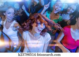 smiling friends dancing in club