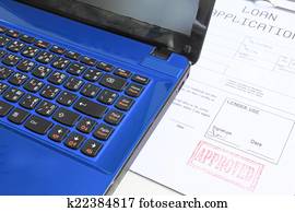 computer notebook with loan approved 