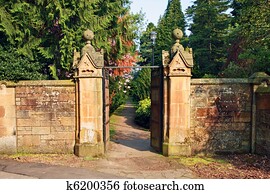 Old, stone garden wall with metal gate Stock Photograph | k9908926 ...