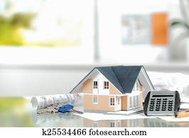 Toy House on the Table with Keys and Calculator