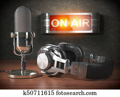 Vintage microphone and headphones with signboard on air. Broadcasting radio station concept. Vintage microphone and headphones with signboard on air. Broadcasting radio station concept.