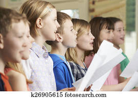 Group Of School Children Singing In School Choir