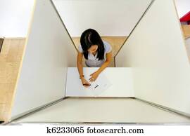 Woman in a voting booth