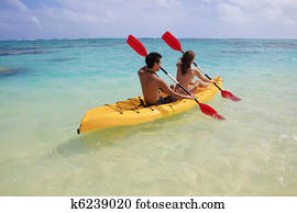 young couple kayaking in hawaii young couple kayaking in hawaii